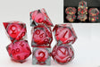 Set of red and clear polyhedral dice with numbers on a white background