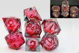 Set of red and clear polyhedral dice with numbers on a white background